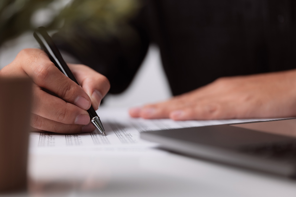 photo of man signing documents for El Apostille